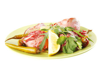 uncooked meat medallion on green