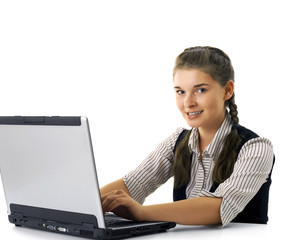 The happy girl works on the laptop