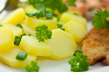 Potatoes with herbs and schnitzel