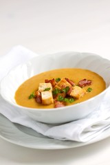 vegetable puree soup with rusk, bacon and parsley