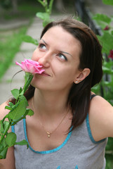 Woman smells a rose