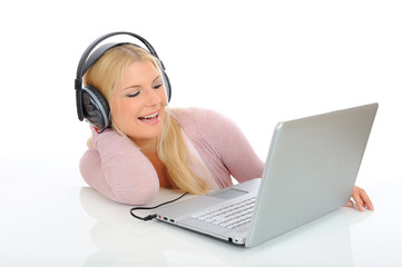 young girl listen and sing to the music with headphones, laptop