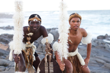 zulu dancer men on beach - obrazy, fototapety, plakaty