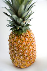 Ripe pineapple on a white background