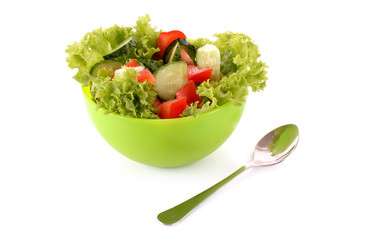 Green salad, cucumber and tomato in green plate isolated on whit