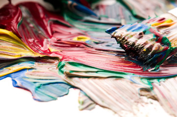 Brush mixing paint on palette