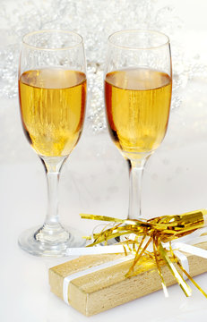 two glasses of champagne with present and horn