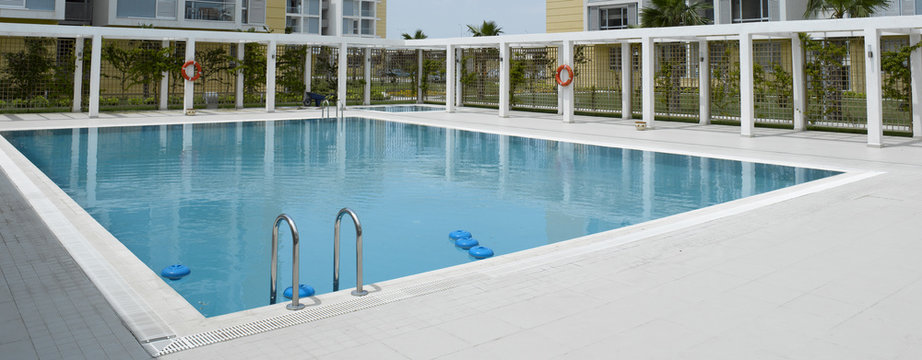 An image of blue swimming pool in summer