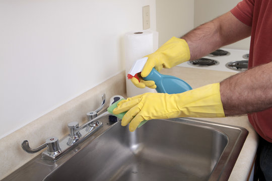 Man Cleaning The Sink