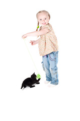 Obraz premium Little girl playing with kitten