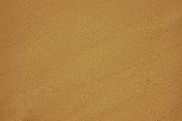 Fototapeta na wymiar Abstract Background Texture of Wet Sand on a Beach
