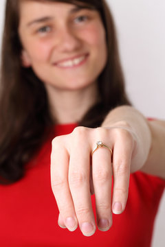 Happy young woman showing her engagement ring