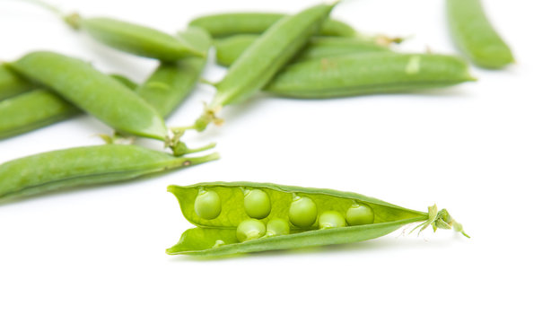 fresh green peapods on white surface; isolated