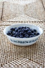 Blueberries in bowl on place mats