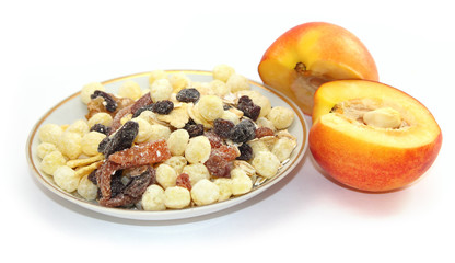 Breakfast cereal with dried fruits and fresh peaches