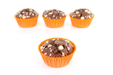 four brown homebaked cupcake over white background
