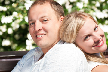 Fototapeta premium Young couple sitting in park