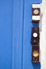 Doorbells on weathered door