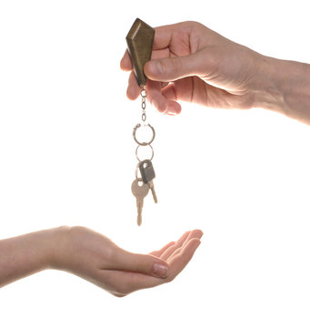 business man give to woman a key isolated over white