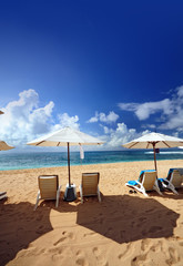 Beach scenery with chairs and umbrella