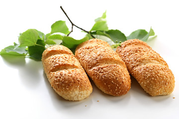 Three bread rolls with birch leaves