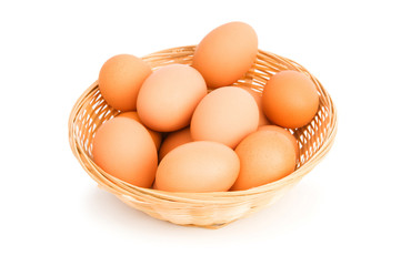 Brown eggs in the basket on white