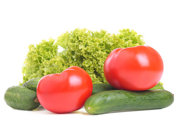Fresh tomatoes, cucumbers and leaf lettuce on white