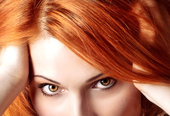 Close-up of beautiful woman face with red curly hair