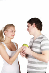 girl treats the young man with apple