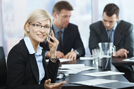 Businesswoman on phone at meeting
