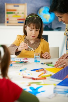Elementary age girl with painting at school