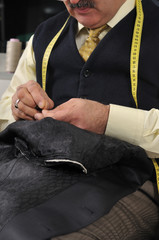 Traditional tailor working at studio