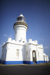 Lighthouse whitewashed with blue skies
