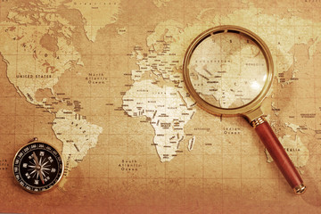 compass on a Treasure map background ,with Magnifier