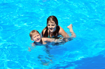 sister teaching brother to swim