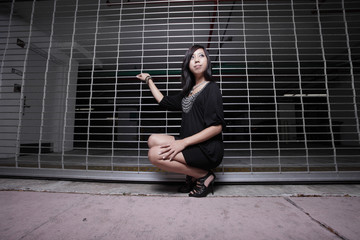 Fototapeta na wymiar Woman posing by a garage gate