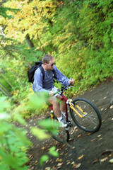 Fototapeta na wymiar Man Riding Trail Bike In Forest