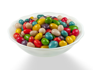 Vase with colorful candy  on a white background