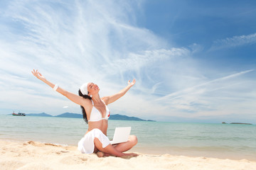 Fototapeta na wymiar Cute woman with white laptop on the summer beach