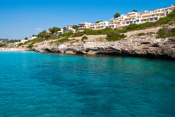 Fototapeta na wymiar Transparent waters of Mediterranean Sea and luxury hotels at Cal
