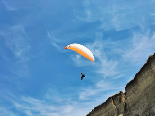 A man flying a paraglider