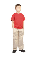 little boy in red shirt hands in pockets standing on white