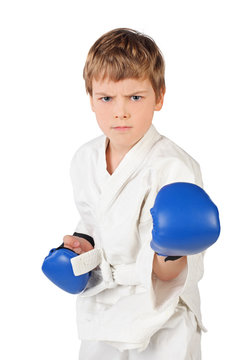 little boxer boy in white dress and blue boxing gloves fighting