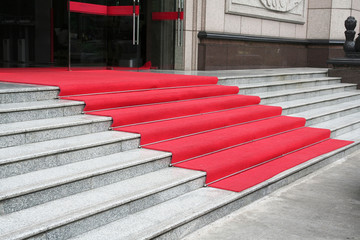 Stone staircase covered with red carpet