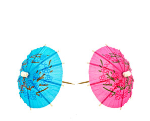 Two cocktail umbrella, blue and pink, man and woman