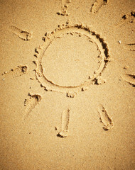 Sun drawn on sand.