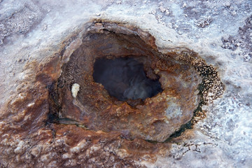 Geyser hole with colored sediments