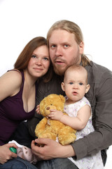 Beautiful family looks at camera. Father, mother and child isola