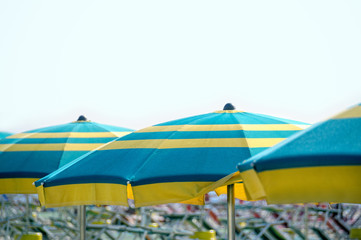 Line of blue and yellow beach umbrellas, Rimini