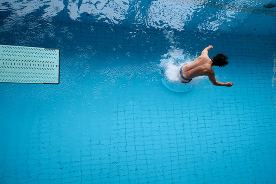 man dives in water - Powered by Adobe